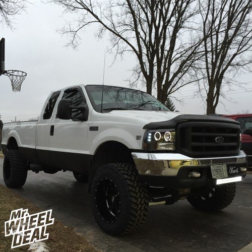 1999 Ford F-350 with 20x12" Black Moto Metal 962 wheels and 35X12.50R20 Nitto Trail Grappler tires 20" Black Moto Metal 962 wheels with 35" Nitto Trail Grappler tires on a 1999 Ford F-350