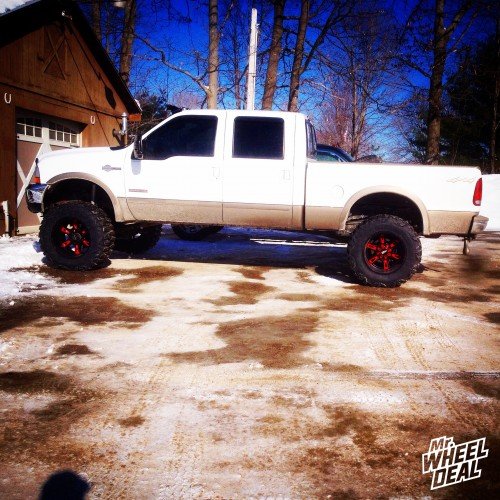 20x12" Black and Red Moto Metal 969 wheels with 37X13.50R20 Nitto Mud Grappler tires on a 2003 Ford F-250 20x12 Moto Metal 969 Black and Red wheels with 37X13.50R20 Nitto Mud Grappler tires on a 2003 Ford F-250