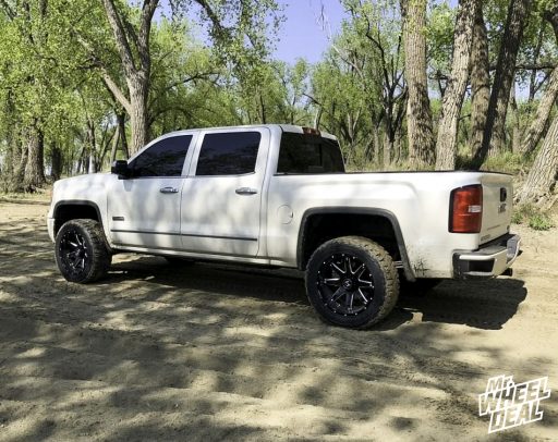Black Milled 20x10 -19mm Hostile Alpha wheels with LT285/55R20 Toyo Open Country RT tires on a 2015 GMC Sierra 1500