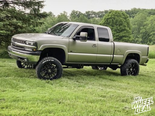 22x12 -44mm Black Milled Hostile Predator wheels with 33x12.5R22LT Nitto Ridge Grappler tires on a 2002 Chevy Silverado 2500