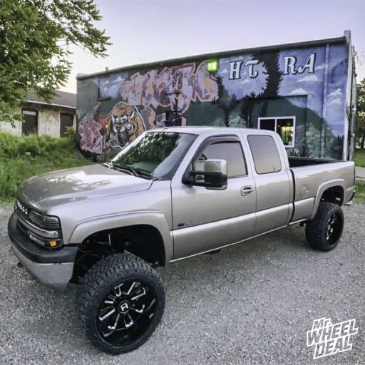 22x12 -44mm Black Milled Hostile Predator wheels with 33x12.5R22LT Nitto Ridge Grappler tires on a 2002 Chevy Silverado 2500