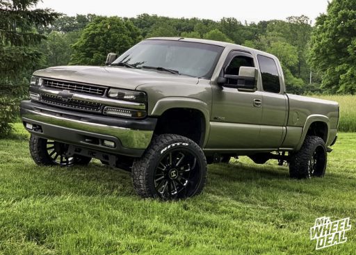 2002 Chevy Silverado 2500 with 22x12 -44mm Black Milled Hostile Predator wheels and 33x12.5R22LT Nitto Ridge Grappler tires