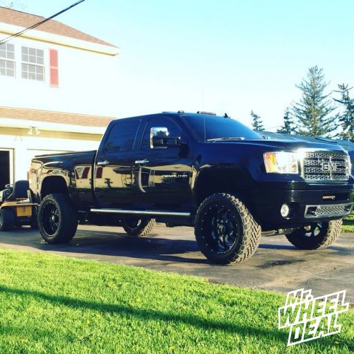 22x10.5 Black Sota Novakane -25mm wheels with LT325/50R22 Toyo Open Country MT tires on a 2013 GMC Sierra 2500HD