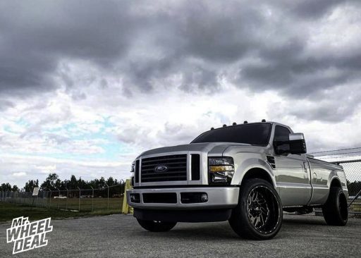 2010 Ford F-250 with 22x12 -43mm Black Milled Fuel Triton wheels and 305/40R22 Nitto NT420S tires